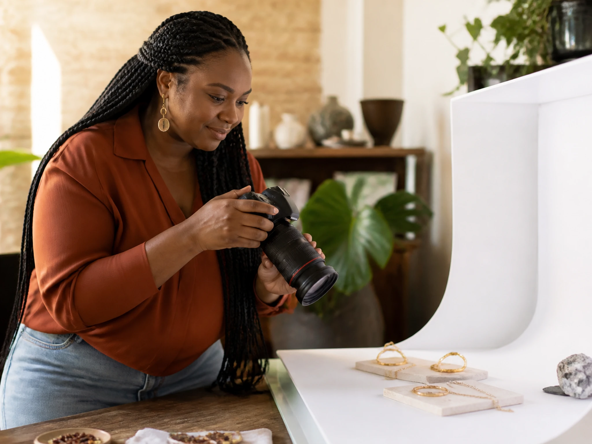 A flatlay of product photos cleanly cut out on white arranged beside a phone